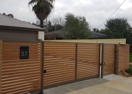 brown fencing at front of house