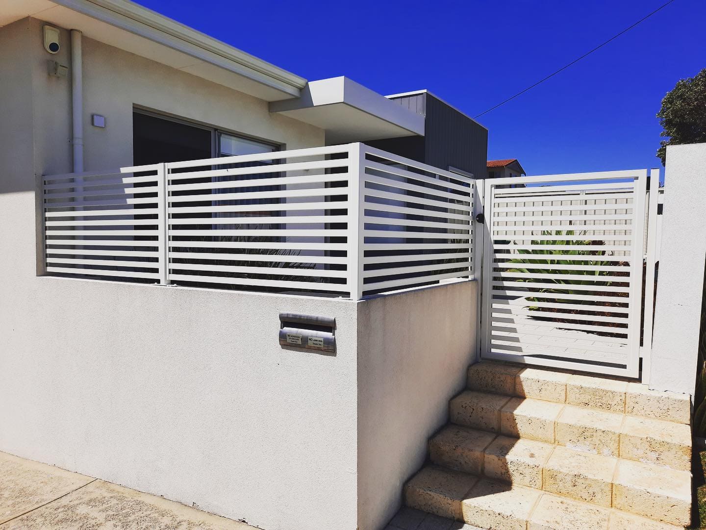 White wall with slat fencing