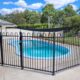 photo of a swimming pool and metal fence