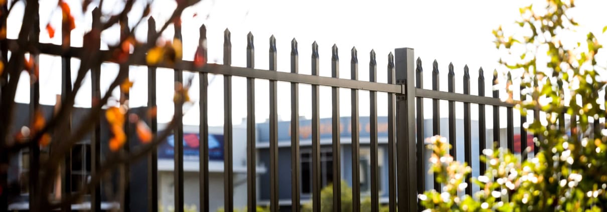 A photo of garrison fencing outside a commercial area.
