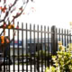 A photo of garrison fencing outside a commercial area.