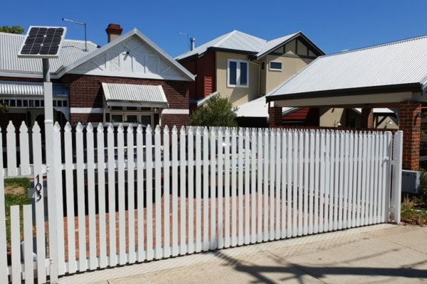 A photo of a white picket fence.